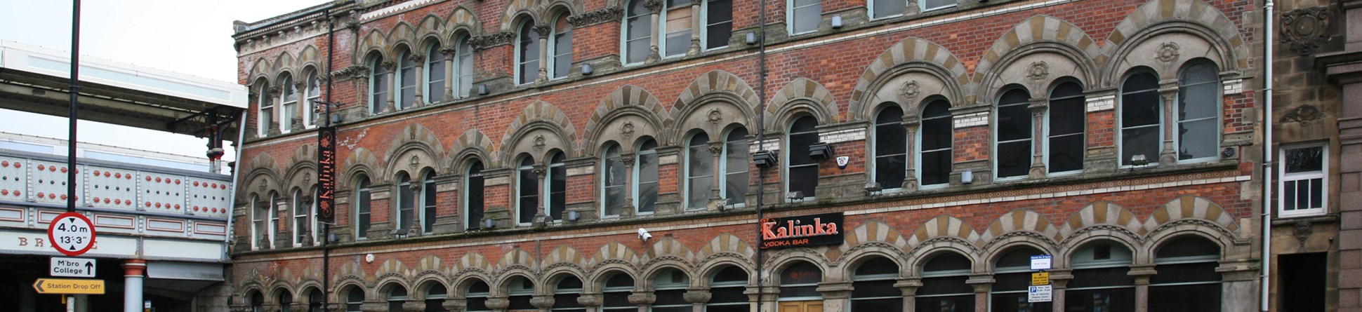 Elevation of a three storey Victorian Gothic style brick building.