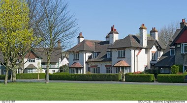 The Oval, Garden Village, Kingston upon Hull showing a communal green space and semi-detached houses with neat hedges.