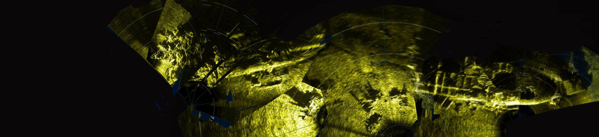 ROV sonar of upside down bow section of the American Landing Ship LST-531. Much of its hull has corroded away revealing the framing of the ship. Vehicles have also spilled out on the left stern section on the far left.