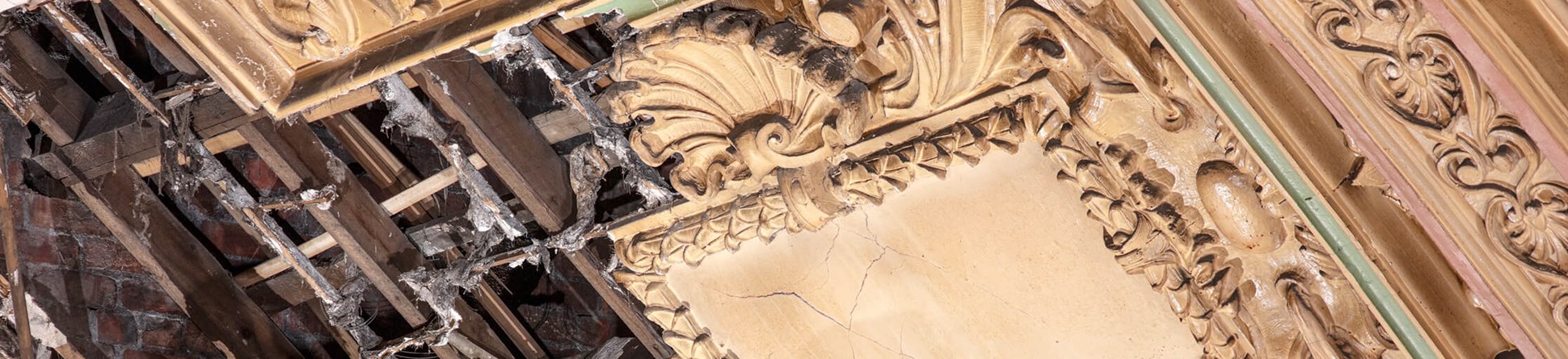 Detail of damaged plasterwork ceiling moulding.