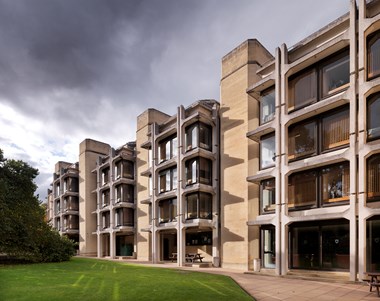 Colour photo of five storey building with external reinforced concrete skeleton.