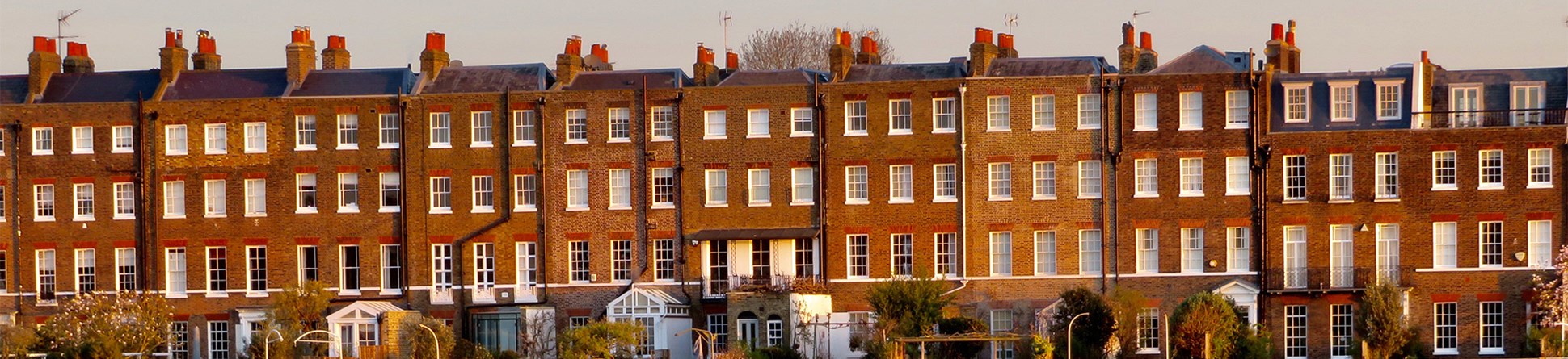 Row of terraced housing reflected in the river