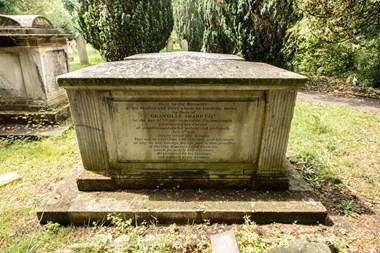 Portland stone chest tomb, with inscription framed by reeded pilasters