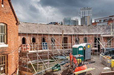 Building under renovation with scaffolding and construction equipment