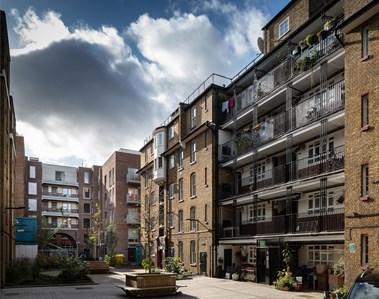 Courtyard within a refurbished and extended group of urban housing blocks.