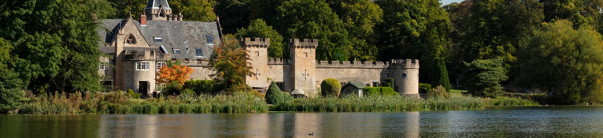 Cannon Fort and surrounding trees viewed across a lake.