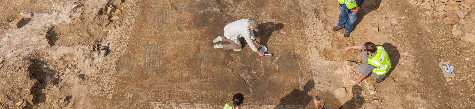 Aerial view of the site and archaeologists at work.