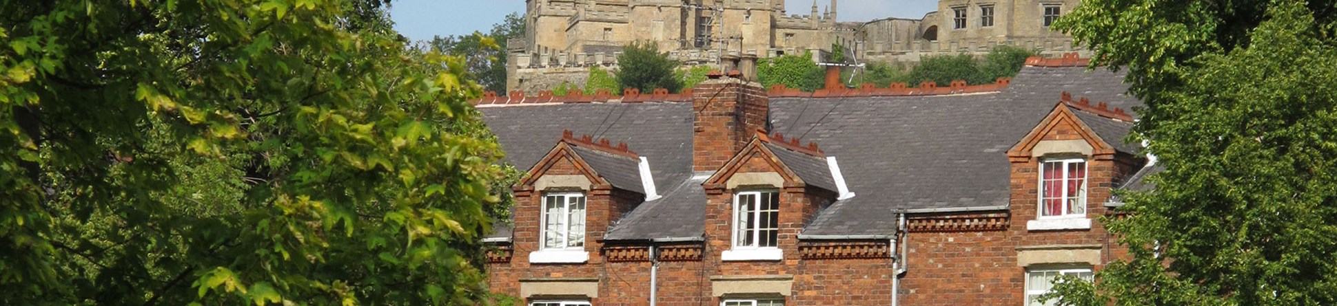 New Bolsover Model Village, Derbyshire, where much of Historic England’s research into energy performance and the effects of measures to increase energy efficiency is being carried out. Bolsover Castle is visible in the background