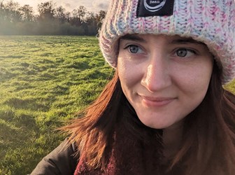 Apprentice Jackie Ann Judge wears winter clothing in a field at dawn