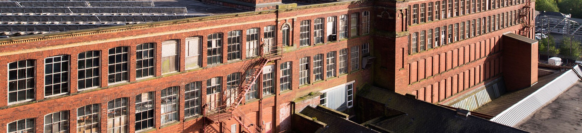 Swan Lane Mill in Bolton, Lancashire. This huge complex comprises three Grade II* listed buildings. When the second mill was completed in the early 1900s it was said to be the largest cotton spinning complex in the world. The building is currently on Historic England's Heritage at Risk Register.