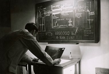 A surgeon examining an x-ray photograph