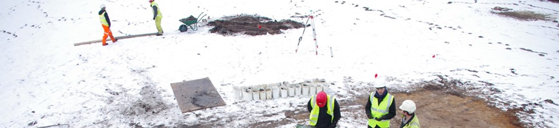 On-site archaeologists discussing methods for excavating an Iron Age furnace at Messingham.