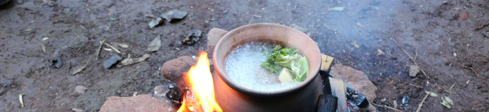 A reconstructed cooking pot and contents over a fire