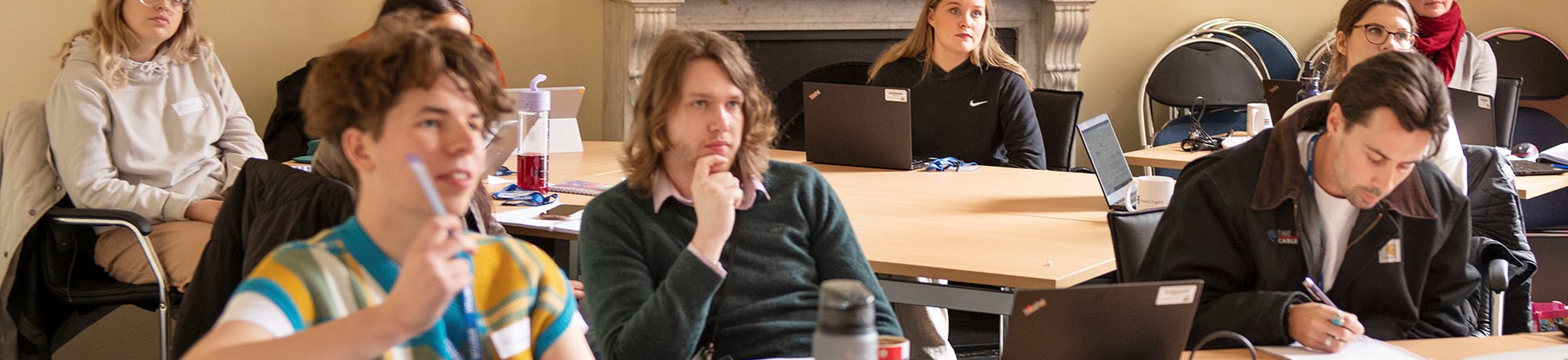 A group of people in a classroom setting