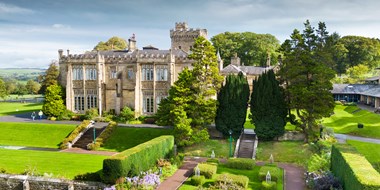 Exterior, drone image of Capernwray Hall and its formal 'Mawson' rose garden. View from west. 