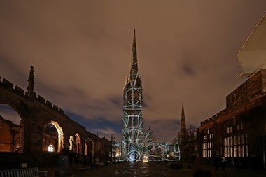 Black and white line drawing of a window projected onto the cathedral building