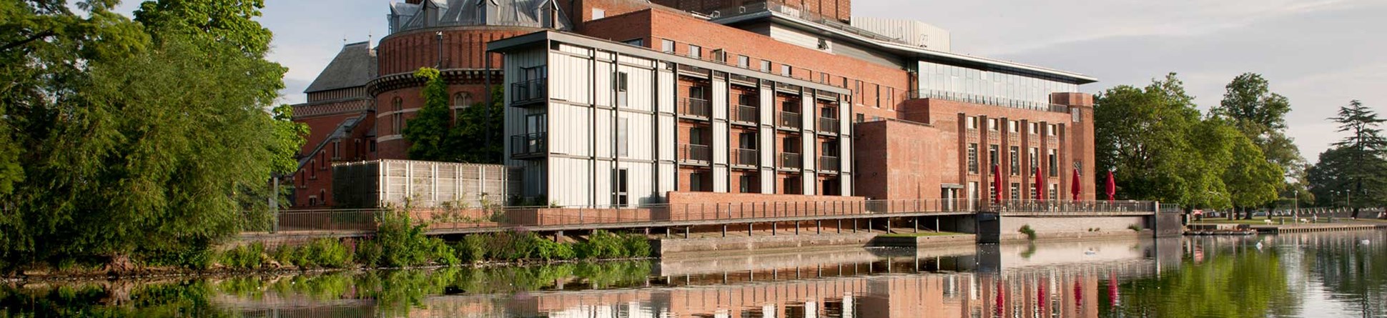 Royal Shakespeare Theatre reflected on the river surface.