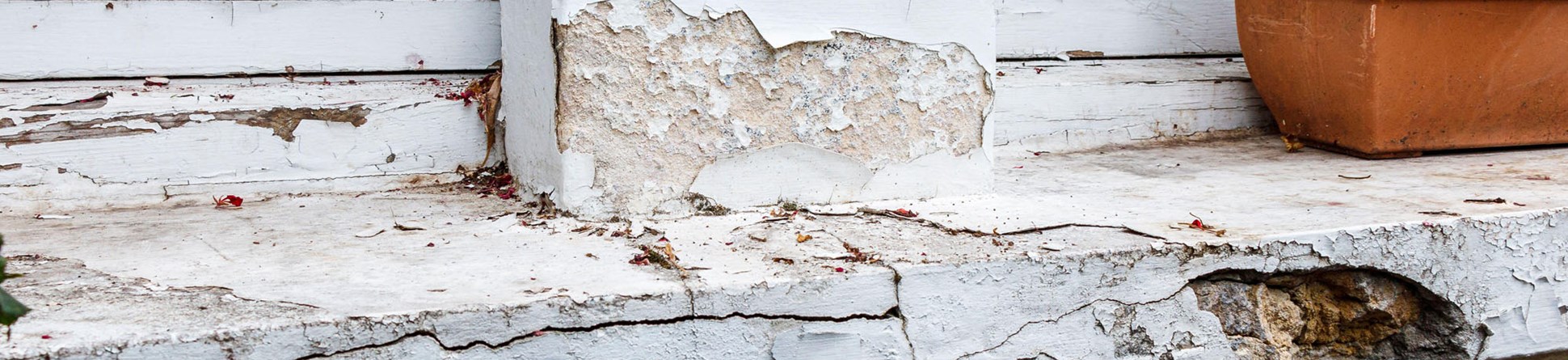 A wooden window frame and windowsill showing signs of decay. 