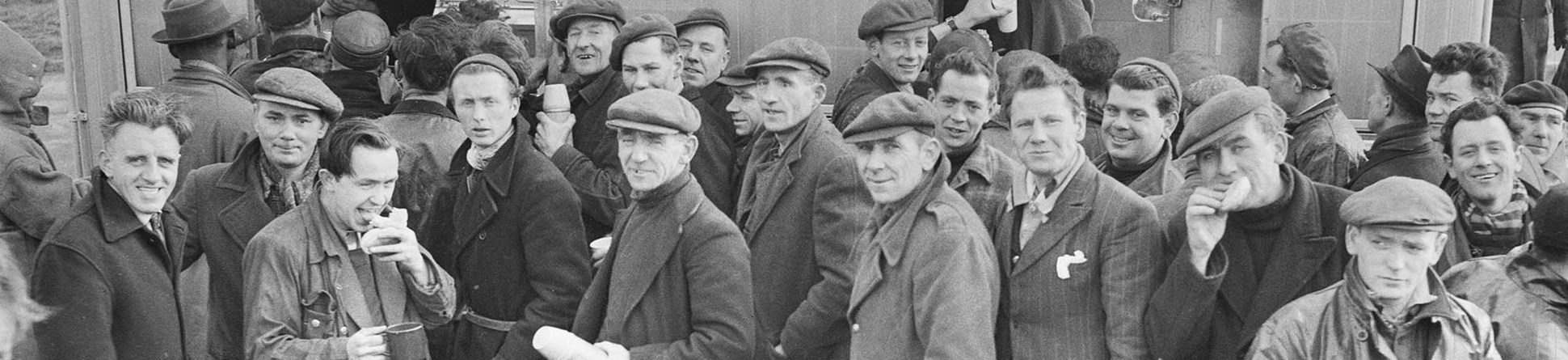 Workers queuing outside a mobile canteen