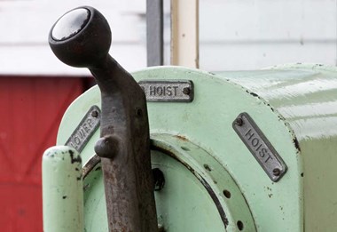 A photograph of a hoist lever in a crane driver's cab.