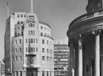 Semicircular front of building with a small transmitter tower at the top