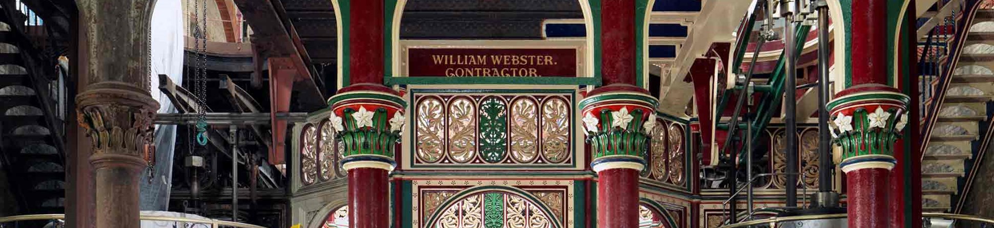 Interior view of the pumping station, looking towards the main atrium space, showing restored and unrestored ironwork