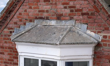 Leaded bay window roof on an old building.